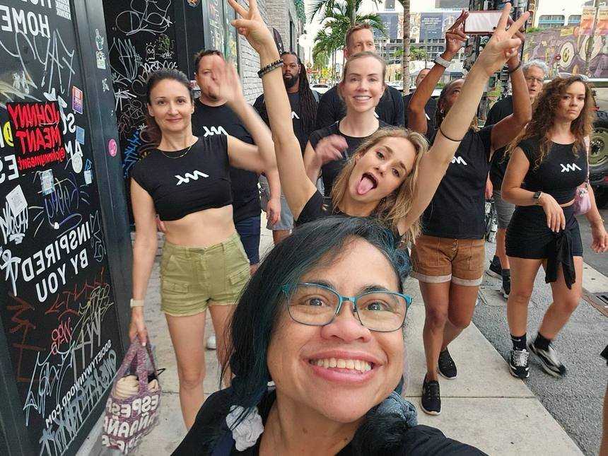 Tere taking a selfie with the group in Wynwood, Miami, all in MetaKizz T-shirts