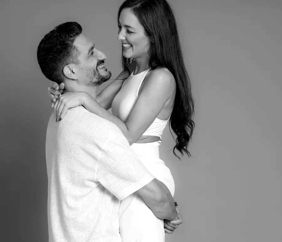 Jesús holding Anni, both laughing
